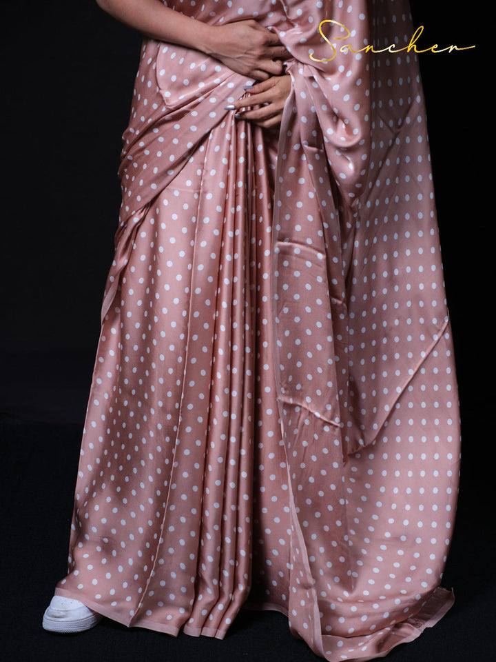 Close-up of dusty rose modal silk saree texture with white polka dot pattern