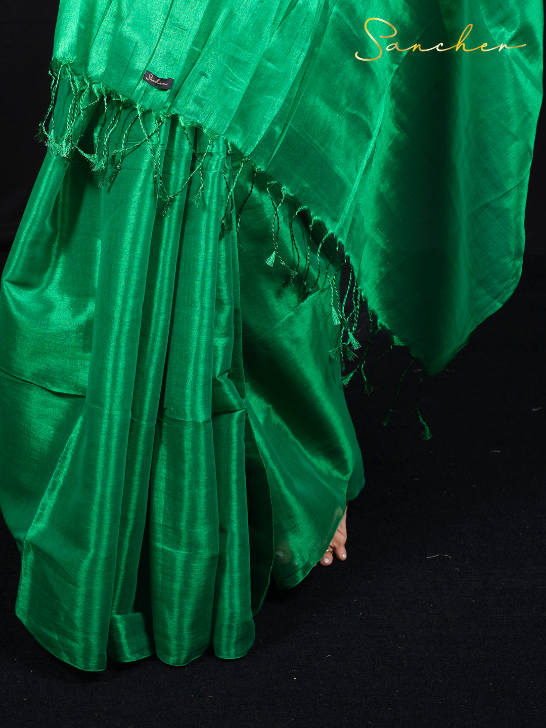 Close-up detail of green mul zari saree fabric showing texture and weave pattern