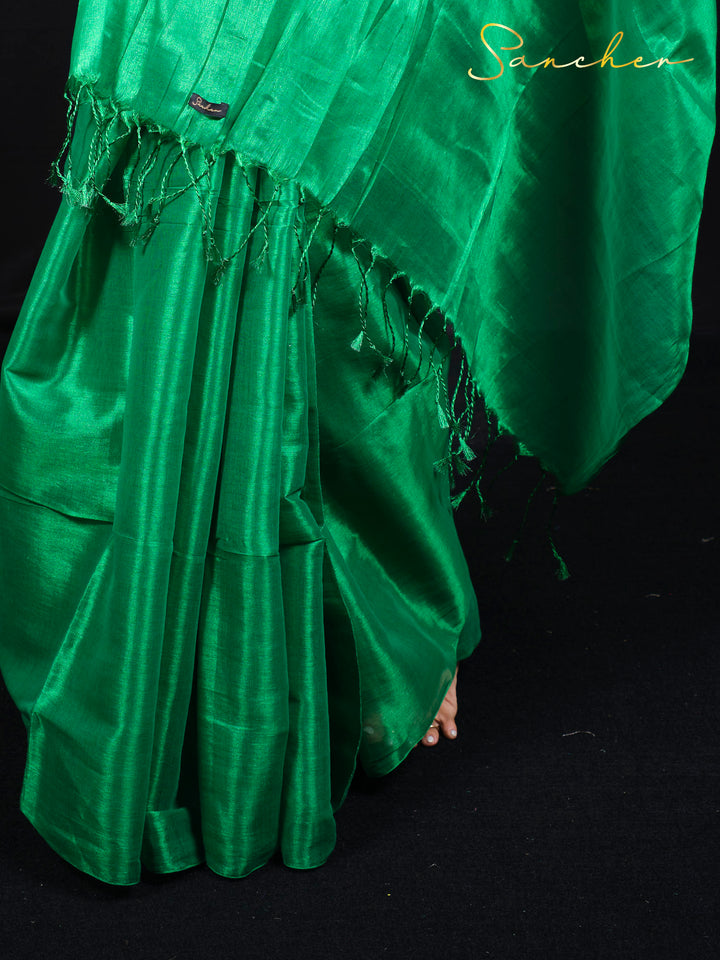 Close-up detail of green mul zari saree fabric showing texture and weave pattern