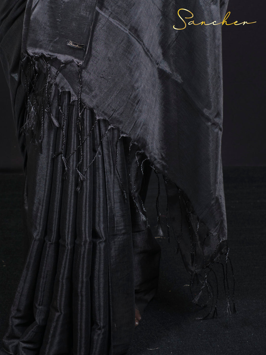 Close-up detail of black mul zari saree fabric showing traditional weave and texture