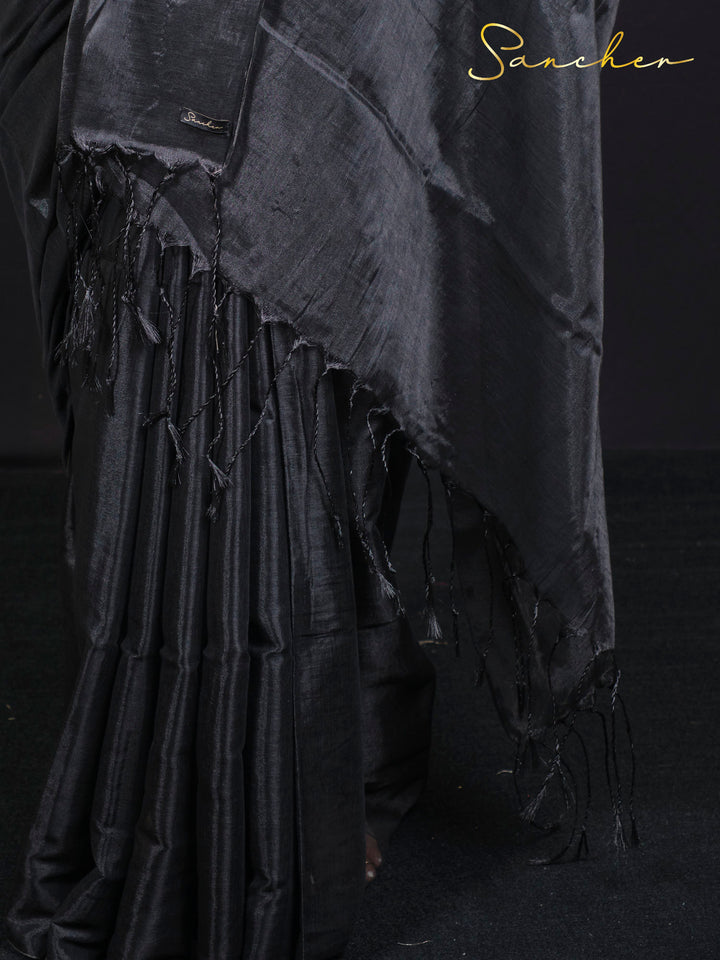 Close-up detail of black mul zari saree fabric showing traditional weave and texture