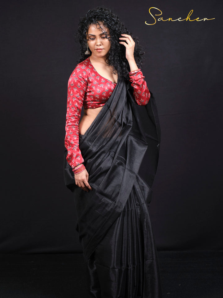 Woman wearing elegant black mul zari saree with red anchor print blouse, traditional Indian ethnic wear