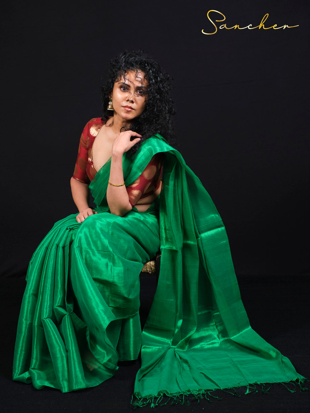 Can you see how beautifully the saree flows and drapes while the model is sitting?