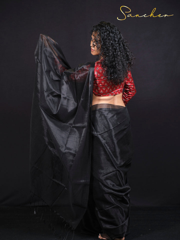 Back view of woman in Black Panther saree showing elegant draping and red anchor print blouse
