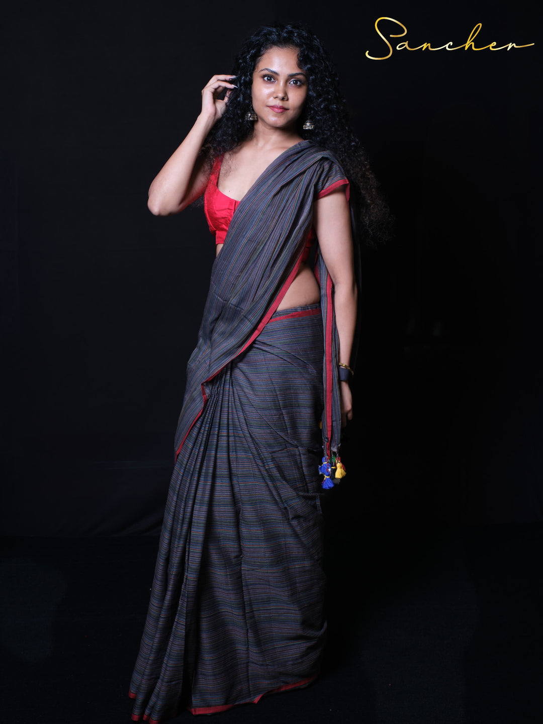 Soft draping mulmul cotton saree with pinstripe texture and vibrant tassels for everyday comfort