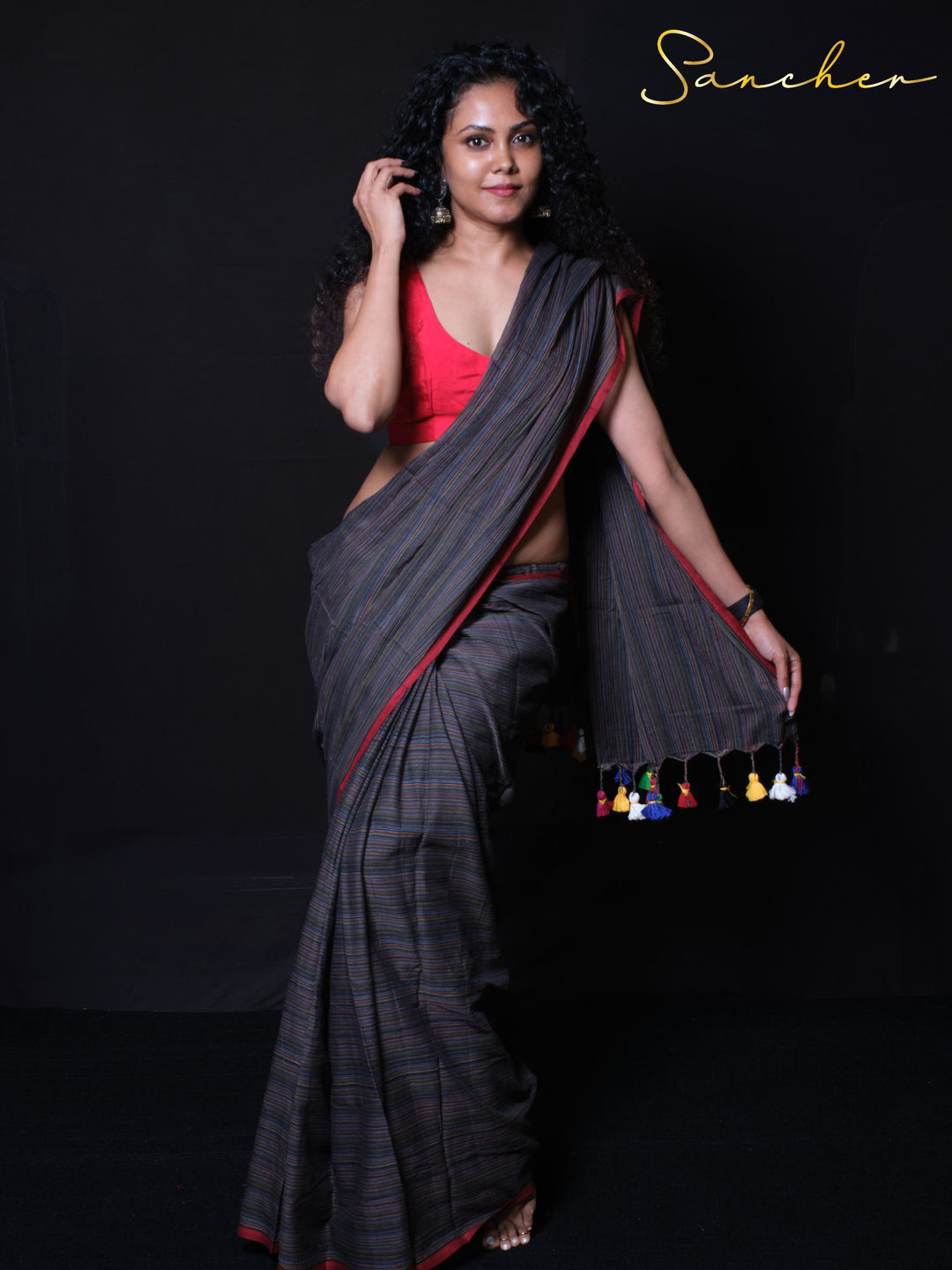 Breathable mulmul cotton handloom saree with red border and multicolored tassels perfect for summer wear