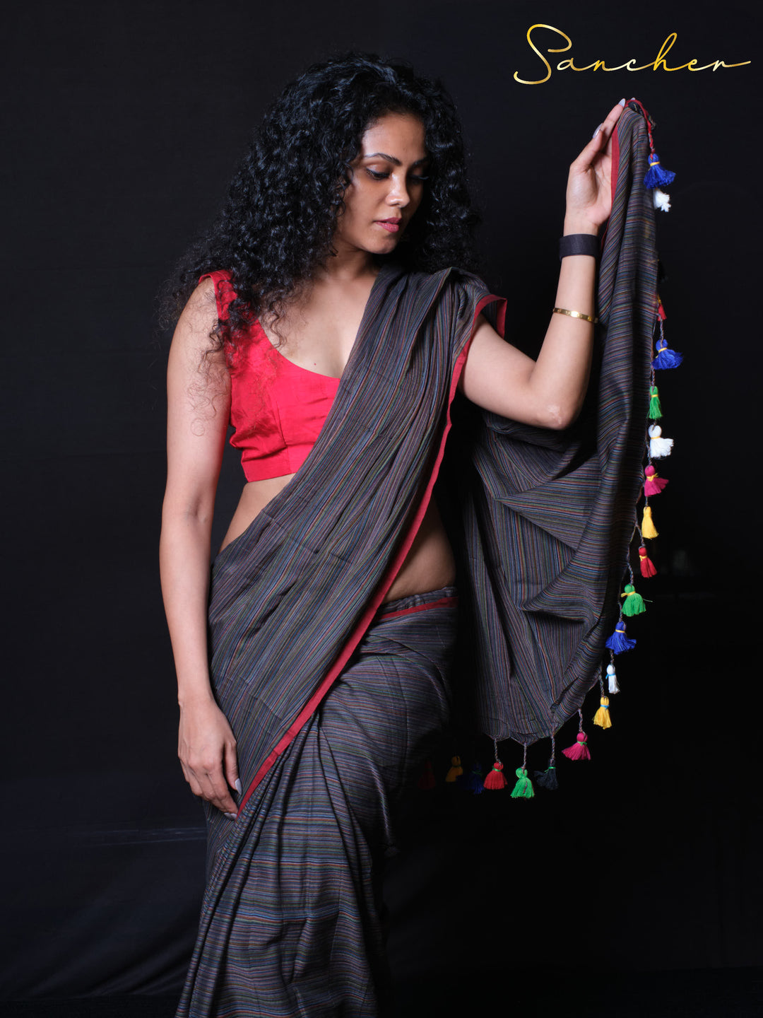 Coastal Charm pinstriped Green Color saree with vibrant red border and colorful pallu tassels side view