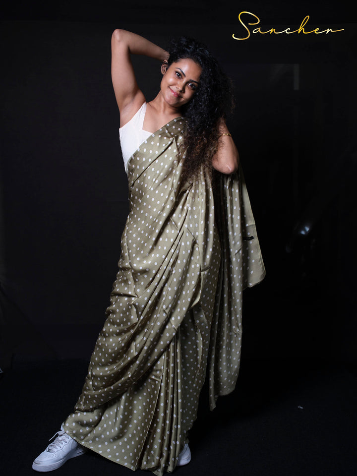 Playful pose in olive green modal silk saree with white sneakers for casual trendy look