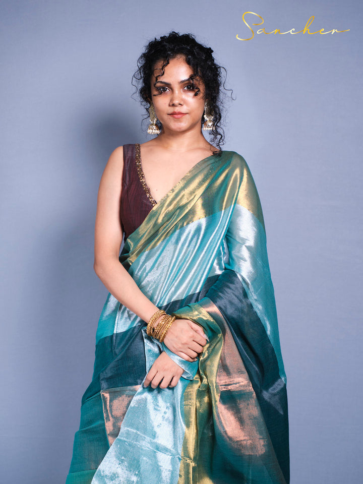 Woman wearing beautiful teal and gold mul zari saree with burgundy blouse for ethnic occasions