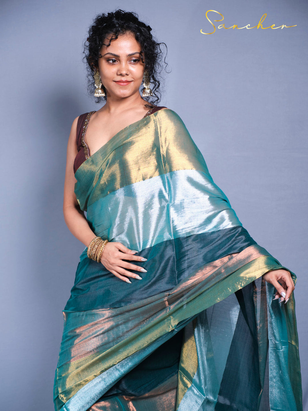 Detail shot of mul zari saree border with decorative tassels and premium cotton fabric