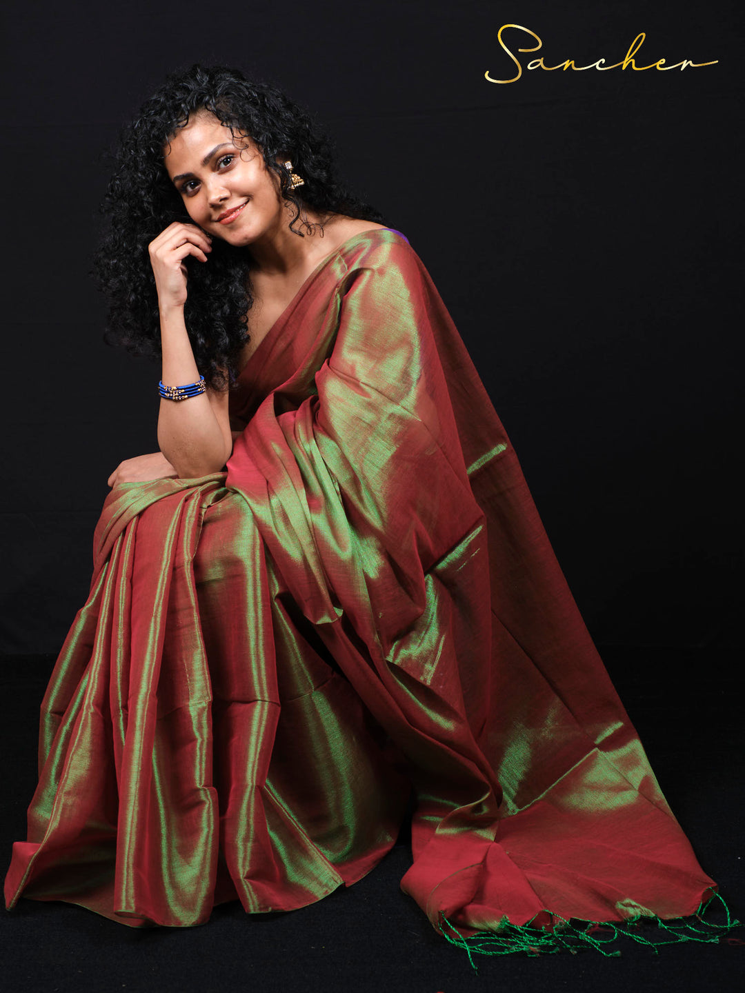 Woman wearing beautiful jade juice mul zari saree in burgundy and green colors