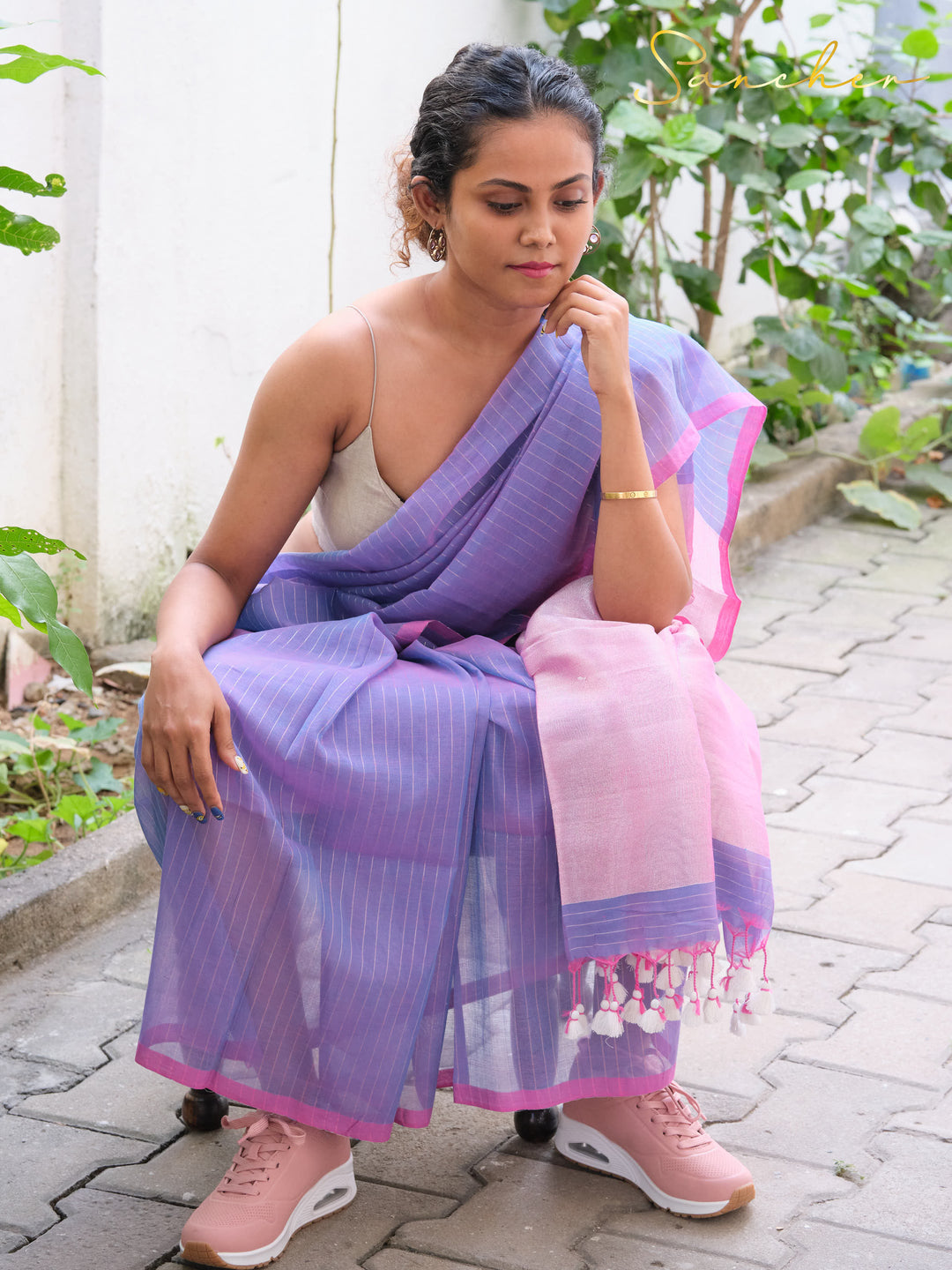Woman wearing lavender and pink mul cotton saree from Anna Nagar boutique, paired with pink sneakers, showcasing casual office wear sarees available at best shops for professional workwear and online purchase.