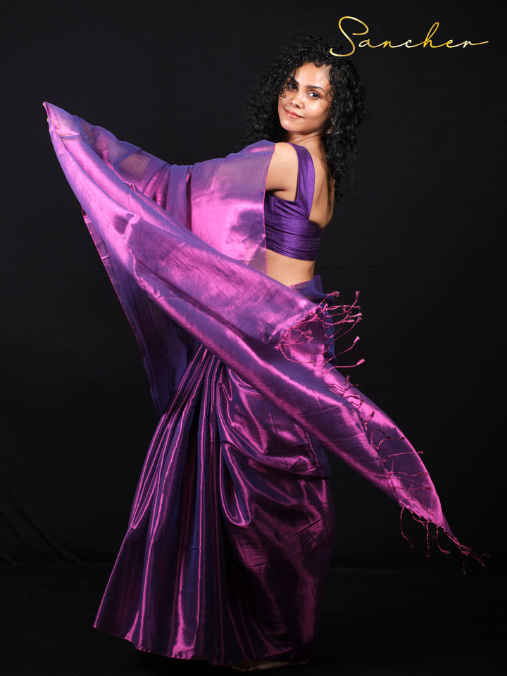 Dynamic pose showcasing purple silk saree flow and movement in studio photography