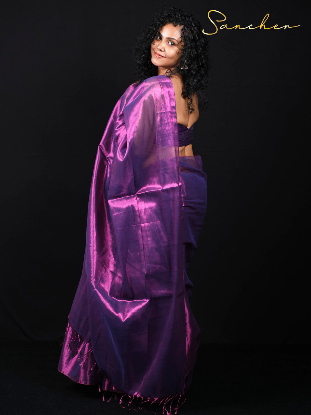 Back view of woman in purple mul zari saree showing elegant draping and fabric fall