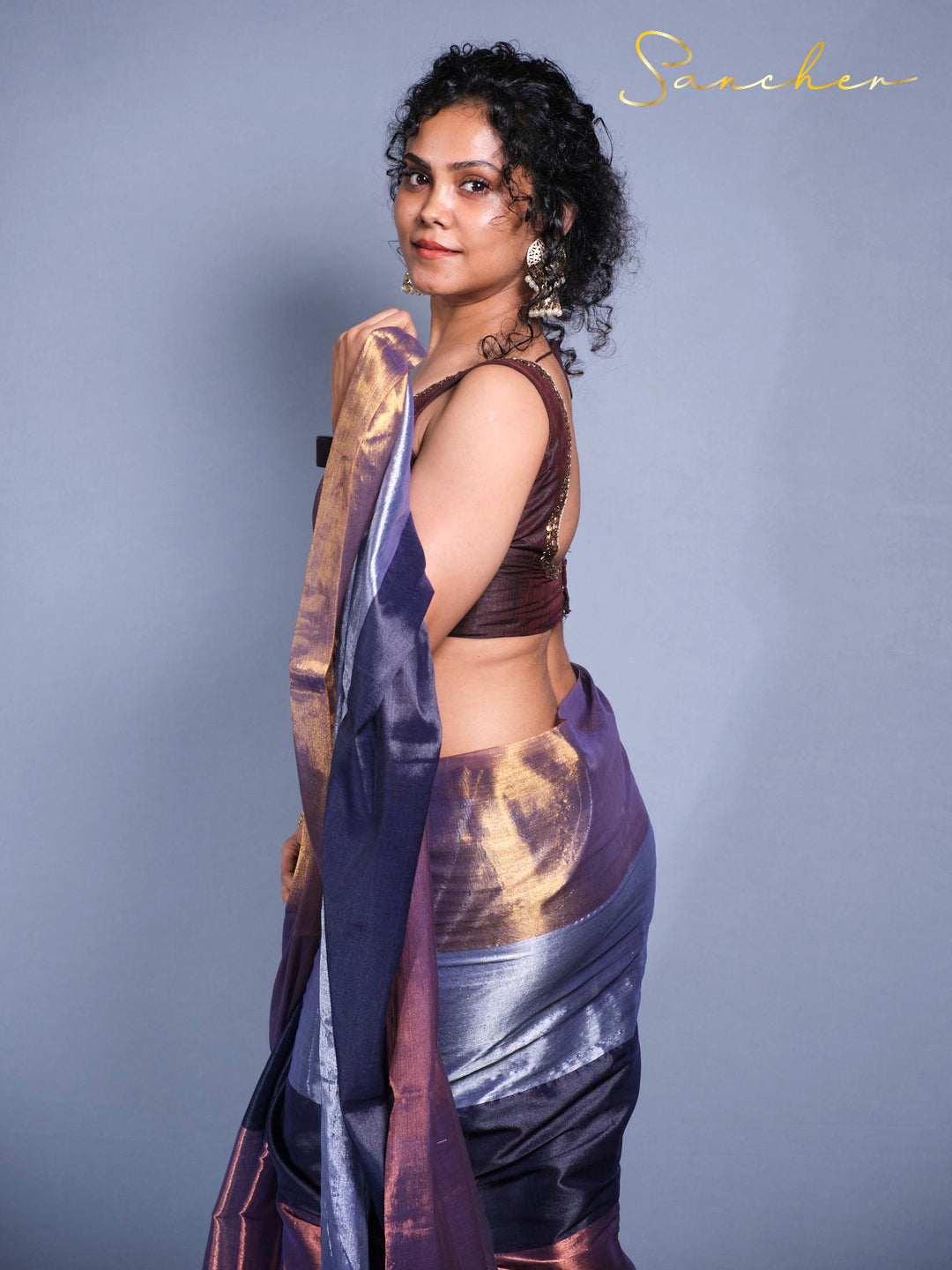 Side pose showcasing Designer Mul Zari saree with iridescent fabric perfect for festivals