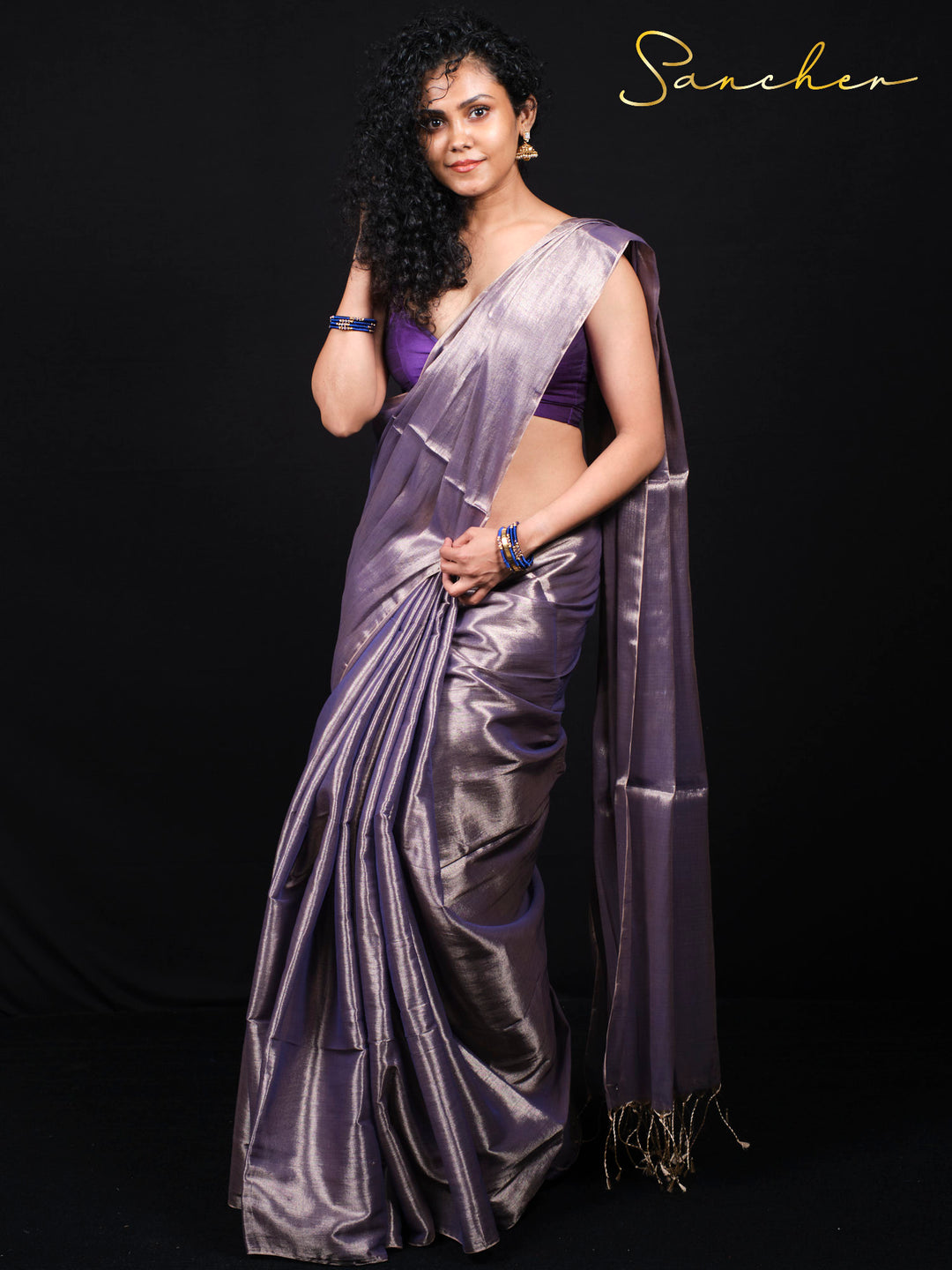 Full-length view of woman in purple mul zari saree with matching blouse piece
