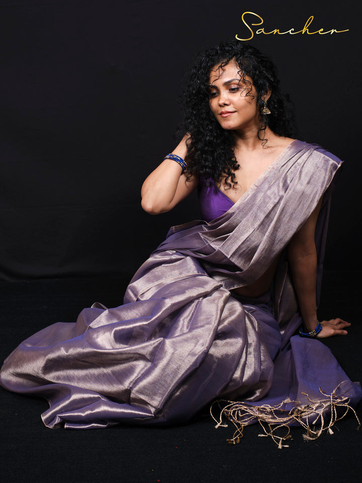 Woman posing in elegant purple mul zari saree showing drape and fabric flow