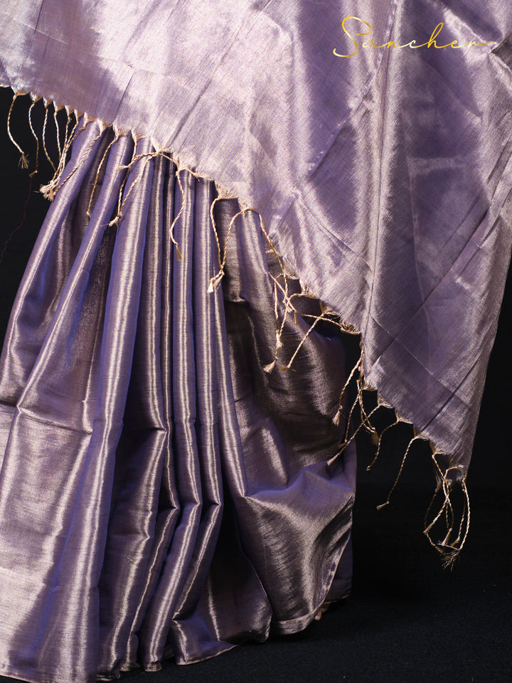 Close-up of purple mul zari saree fabric showing golden thread work and texture