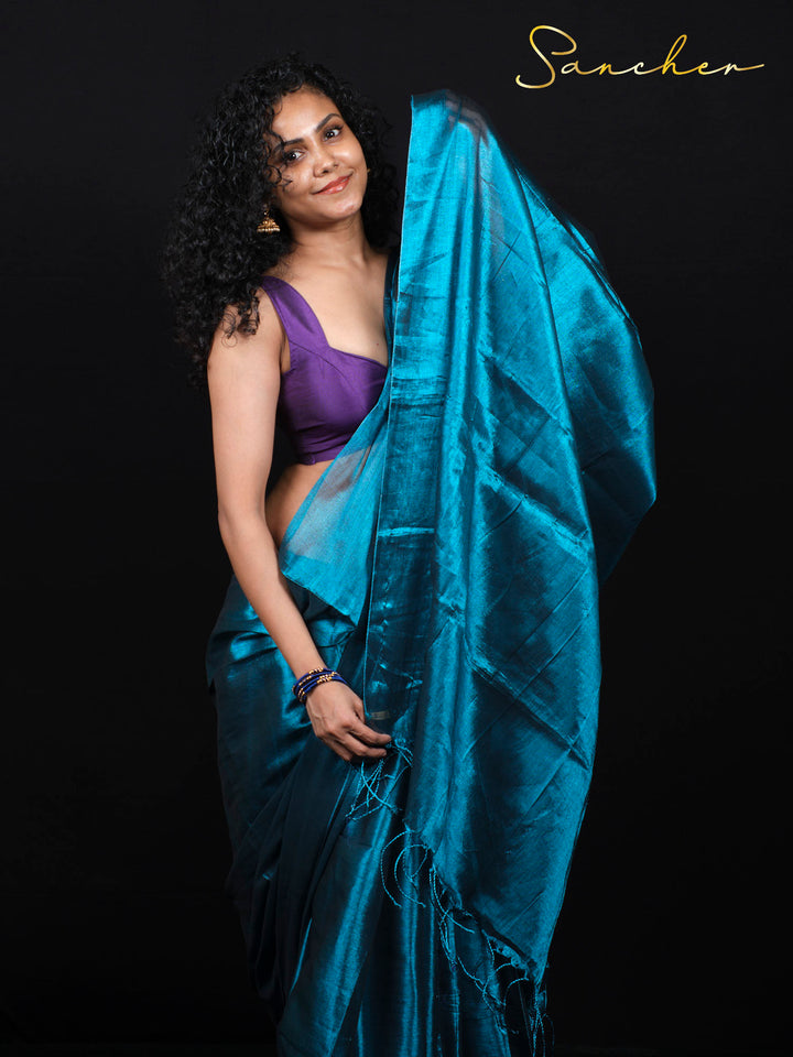 Side pose showcasing the shimmer and texture of premium Mul Zari silk saree in oceanic teal color