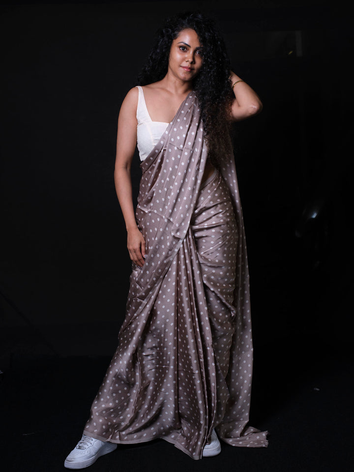 Front view of trendy modal silk saree in dusty taupe color with white sneakers styling