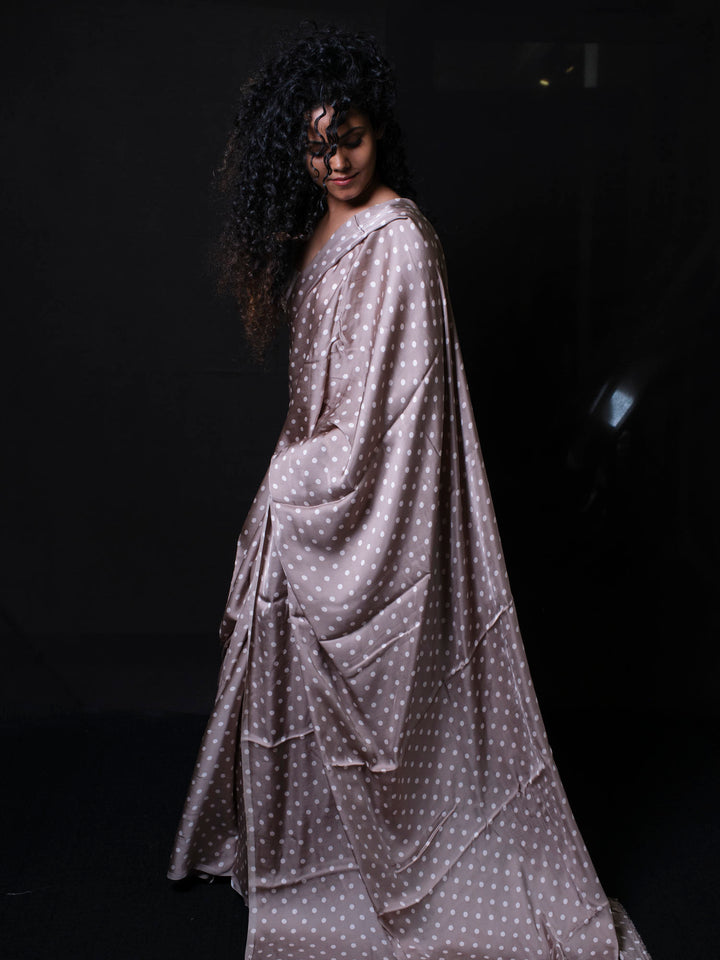 Back view of woman in premium modal silk saree with classic polka dot pattern for office wear