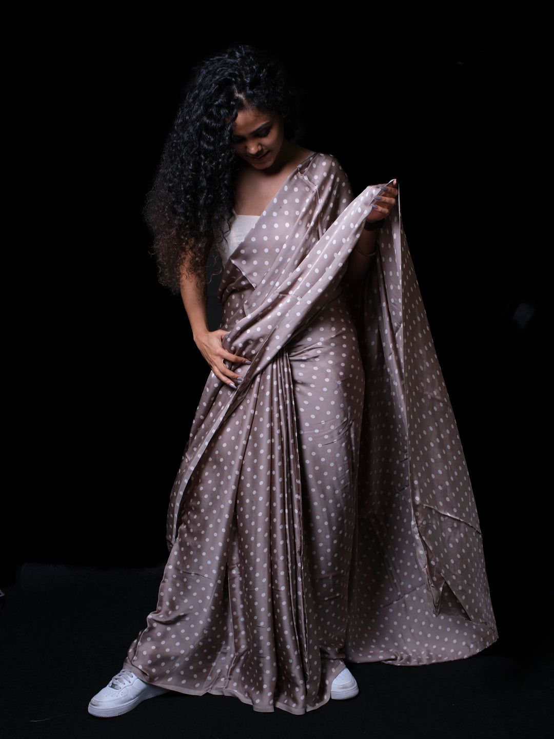 Graceful pose in lightweight modal silk saree with timeless polka dot design for women.