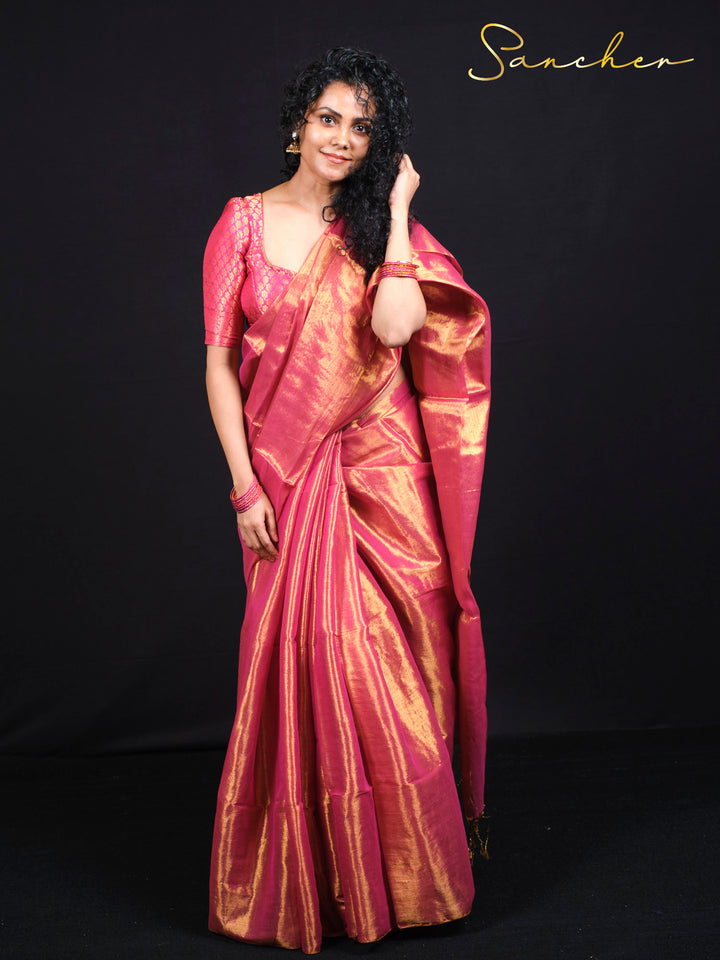Woman wearing beautiful pink mul zari saree with golden work for festival celebration