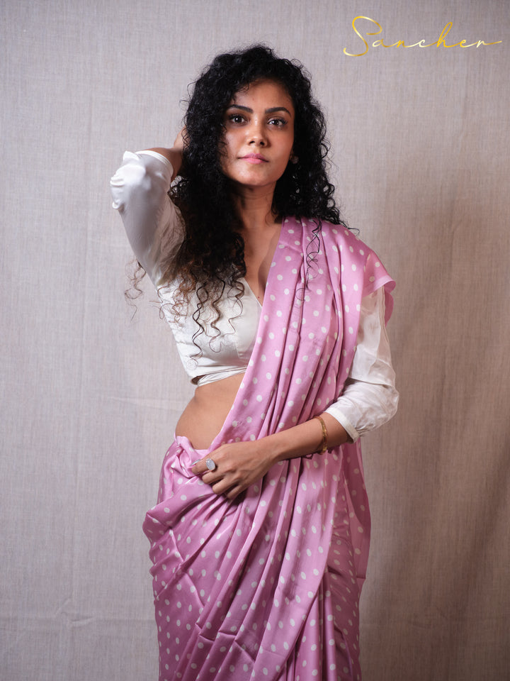 Woman in pink polka dot modal silk saree with white blouse posing elegantly