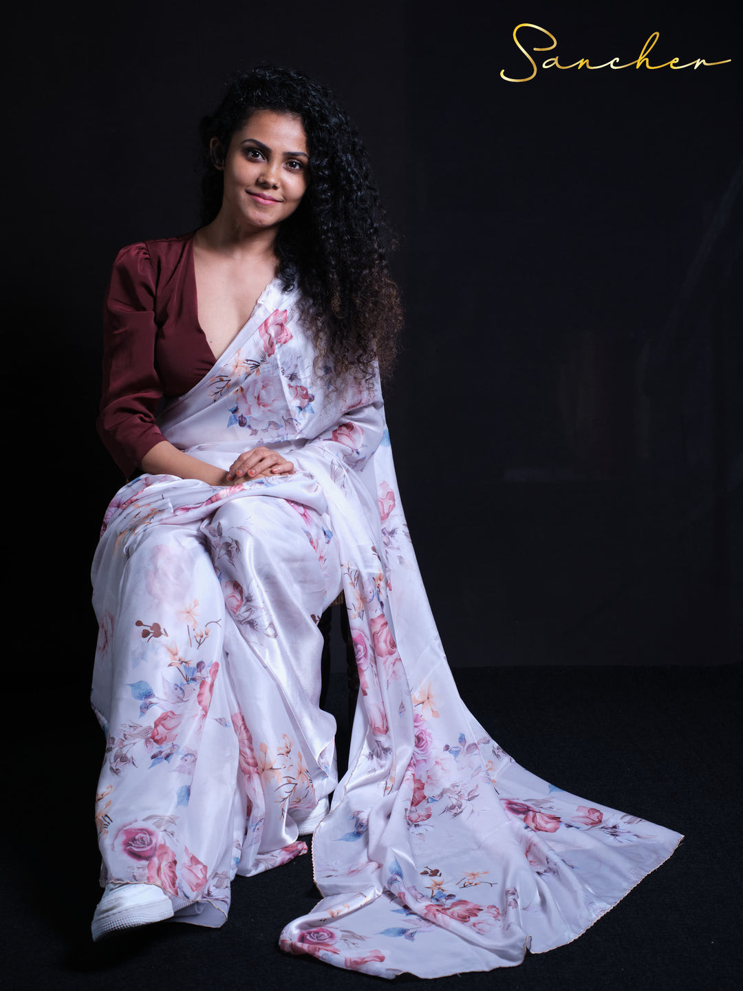 Flowing white satin silk saree with pink rose pattern and scalloped border