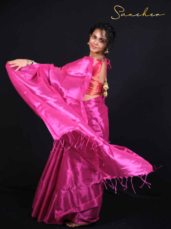Beautiful woman wearing Rose Radiance magenta pink Mul Zari saree with golden patterns for party wear