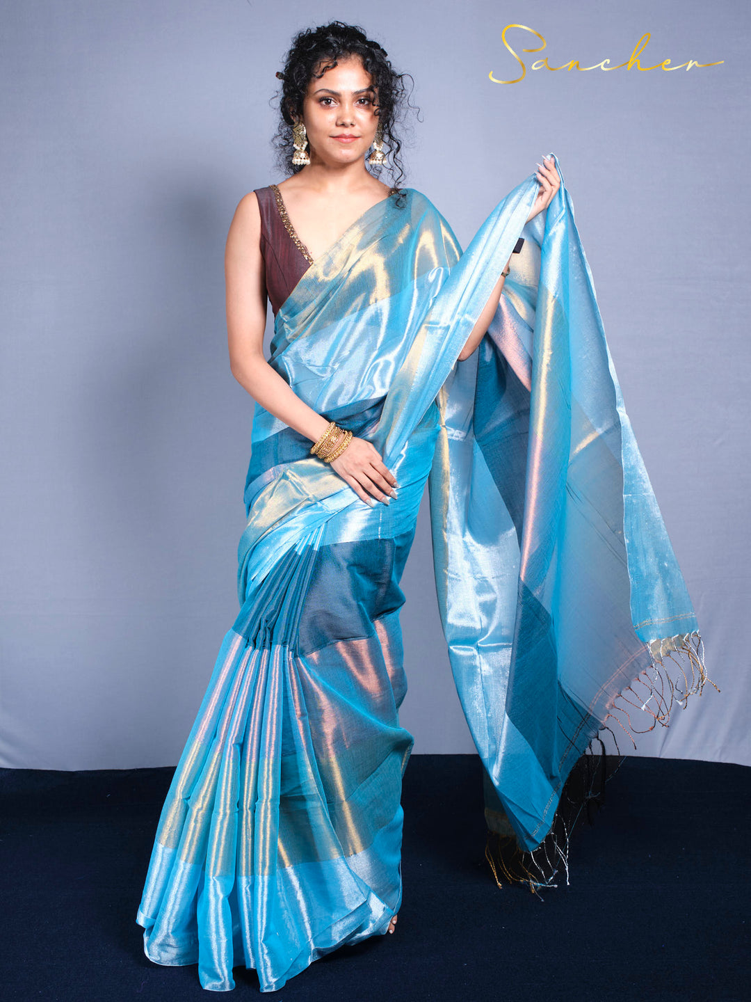 Designer mul zari saree photoshoot showing fabric texture and color-changing shimmer details