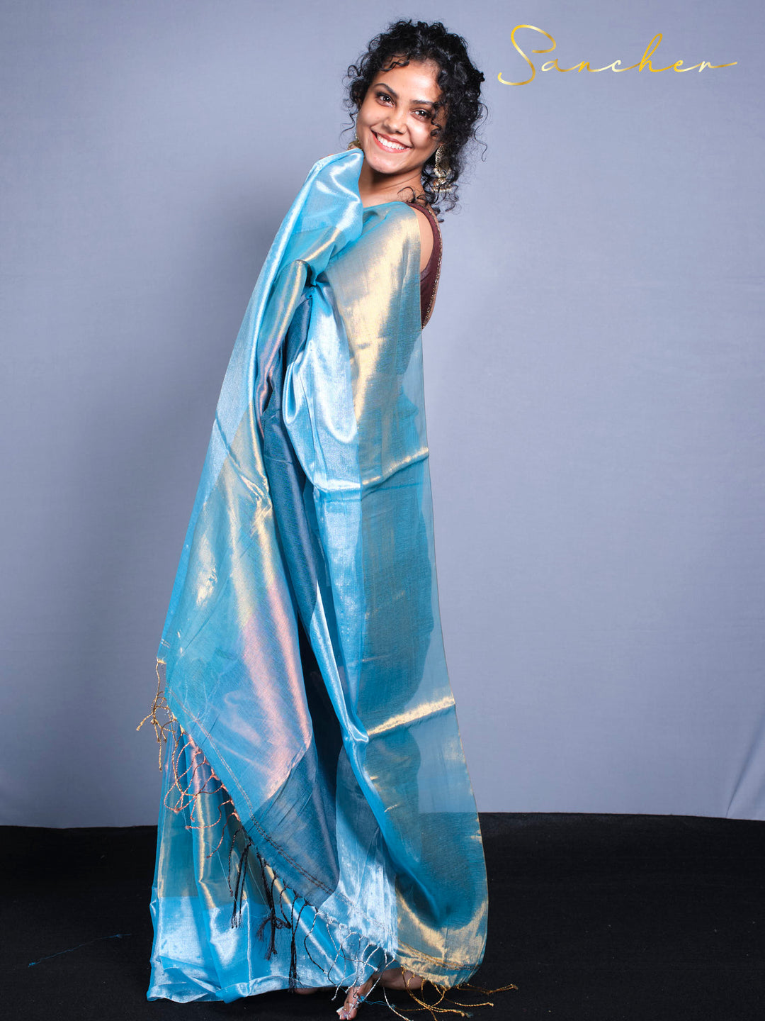 Festival wear saree in shimmery blue fabric with handwoven zari work and fringe border