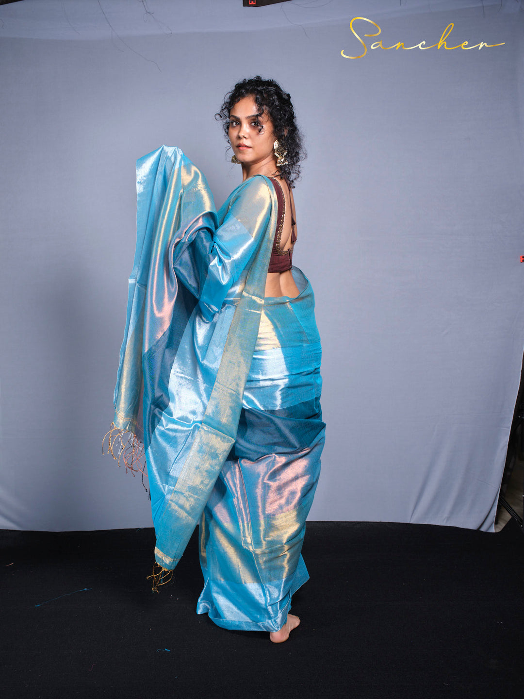 Professional saree photography featuring iridescent blue mul zari with traditional styling