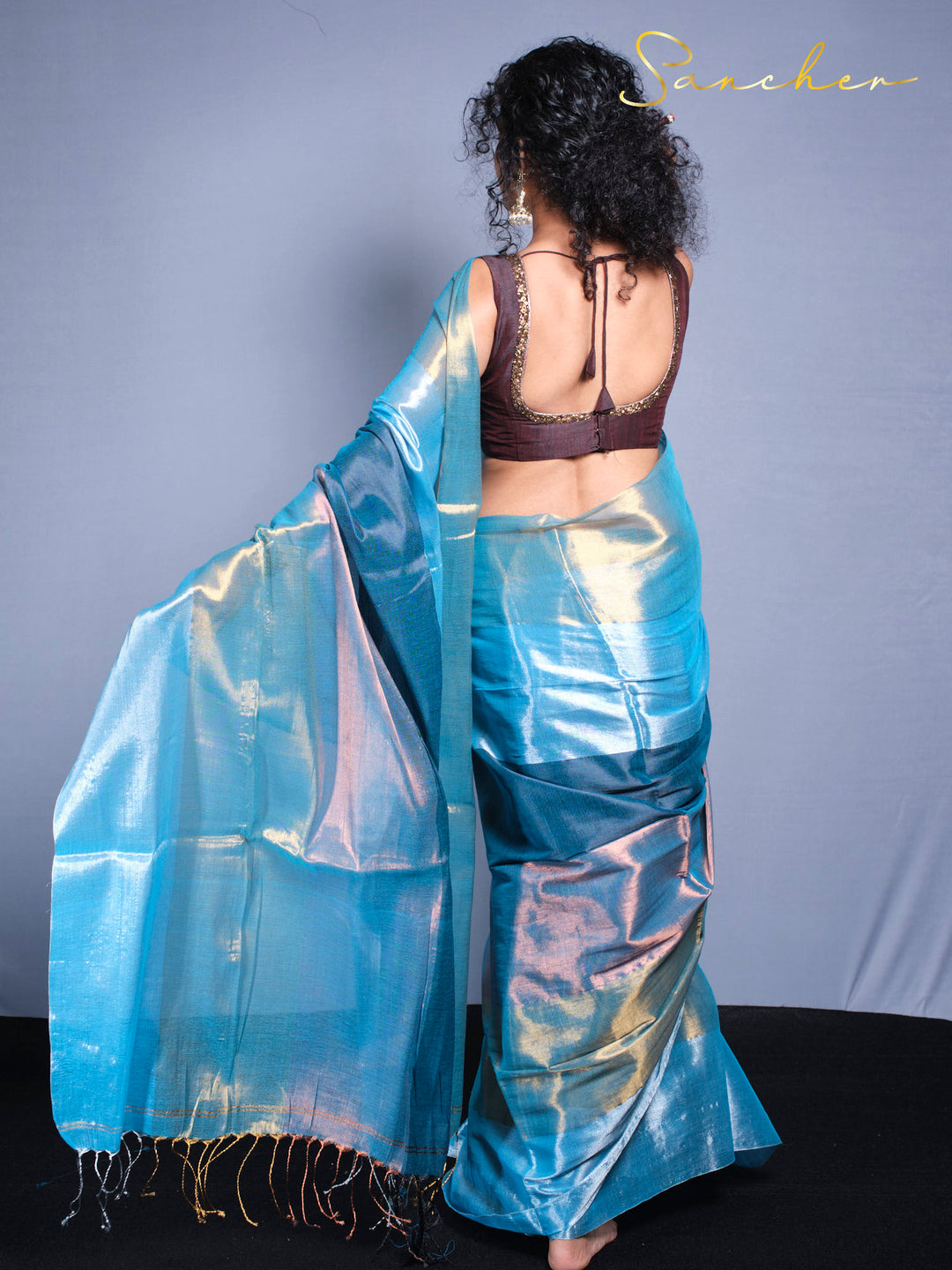 Back pose of view and wearing the authentic Indian model earing the premium Mul zari Saree