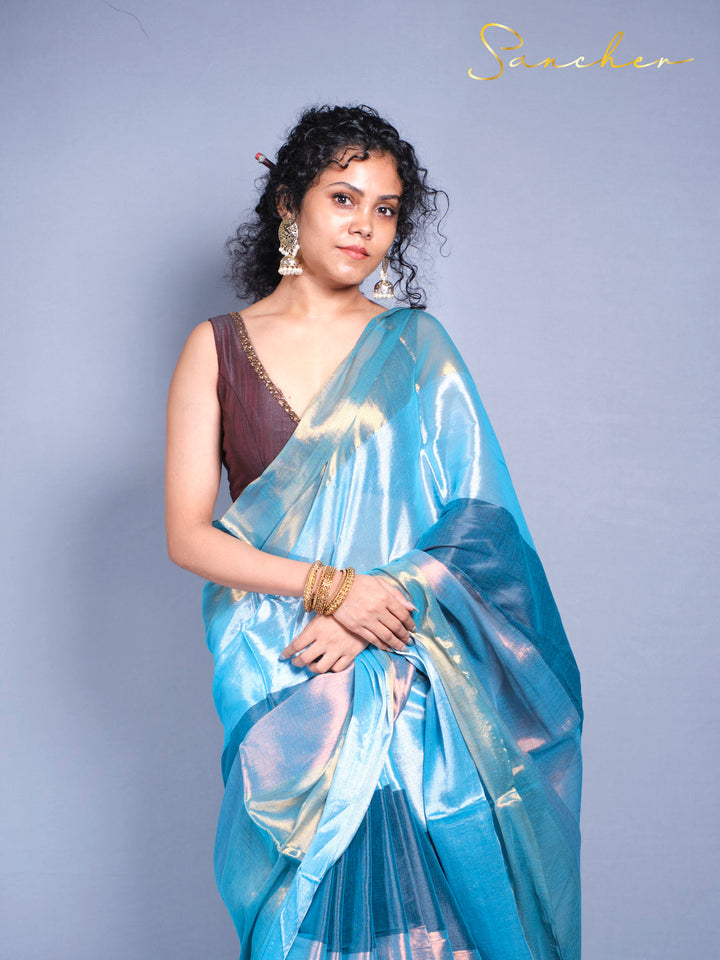 Sea shine iridescent saree with holographic finish and traditional fringed border details