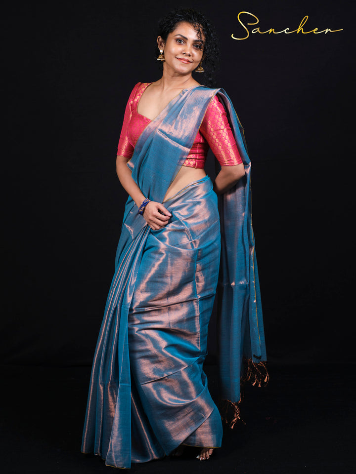 Woman wearing Sancher Serence Sea Blue Mul Zari saree with pink brocade blouse and traditional gold jewelry