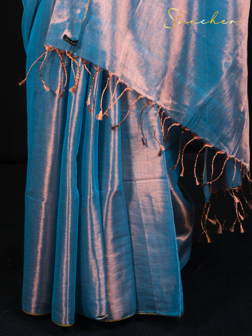 Close-up of Sancher Sea Blue Mul Zari saree showing copper tassels and premium cotton fabric texture