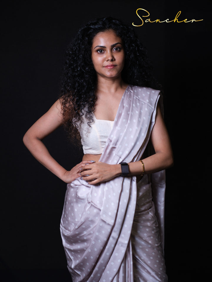 Woman wearing soft Gray modal silk saree with white polka dots and white crop top blouse