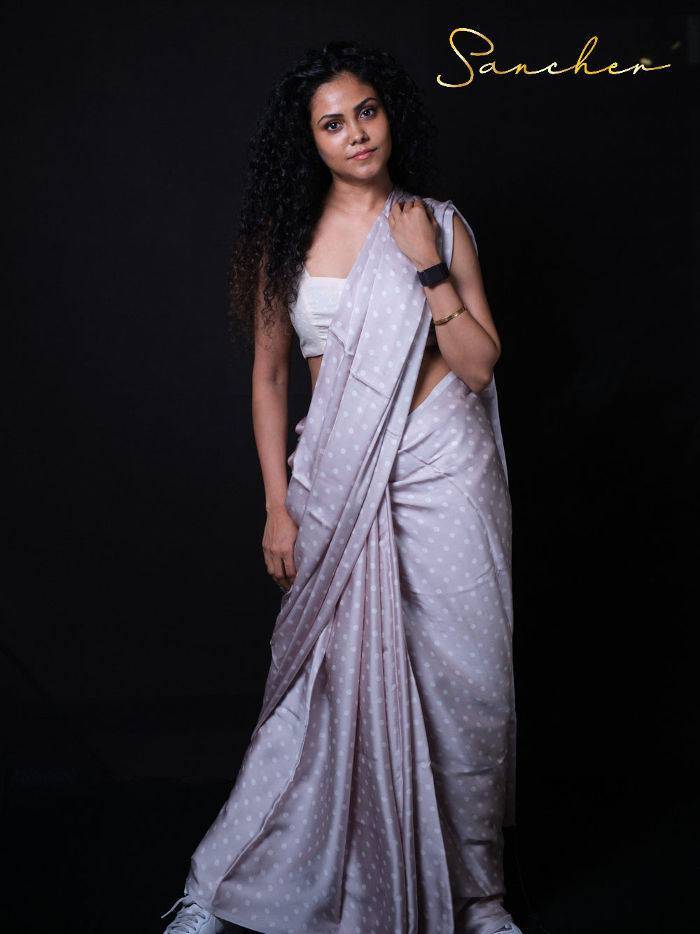 Woman in Modern pose wearing lightweight modal silk saree perfect for office wear