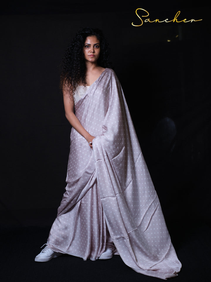 Soft modal silk saree with classic polka dots ideal for party wear and special occasions.