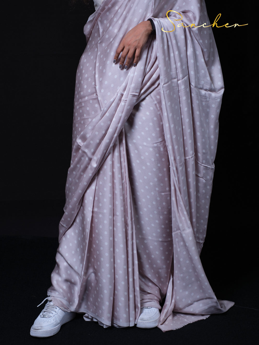 Full length view of Tequila Sour polka dot saree with elegant draping and white sneakers styling