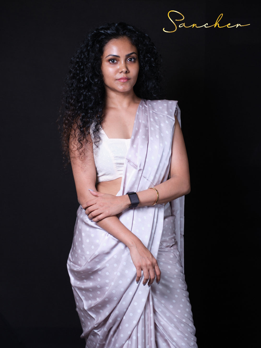 Woman wearing soft Gray modal silk saree with white polka dots and white crop top blouse, perfect for Party wear, Occasional wear, Office wear.