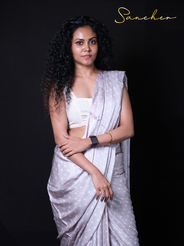 Woman wearing soft Gray modal silk saree with white polka dots and white crop top blouse, perfect for Party wear, Occasional wear, Office wear.