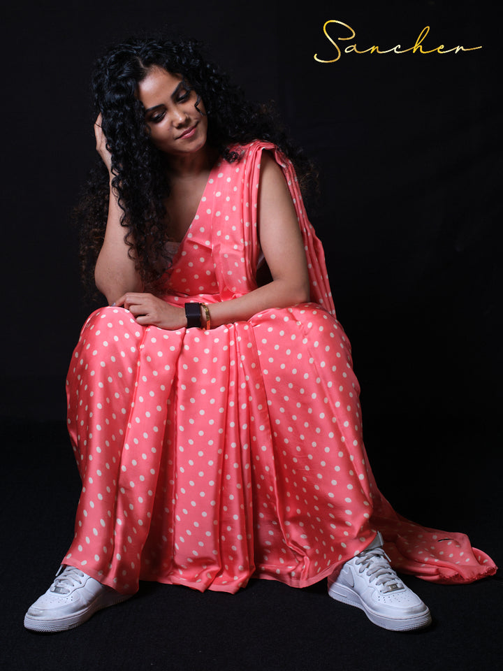 Casual sitting pose in polka dot modal silk saree with modern styling perfect for office wear and party occasions