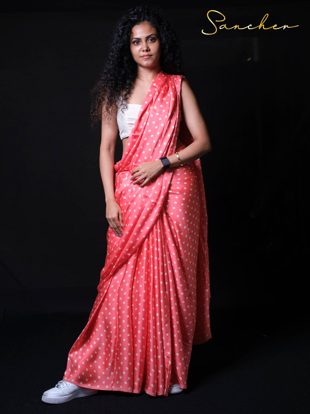 Front view of woman in designer modal silk saree displaying perfect draping and polka dot print design