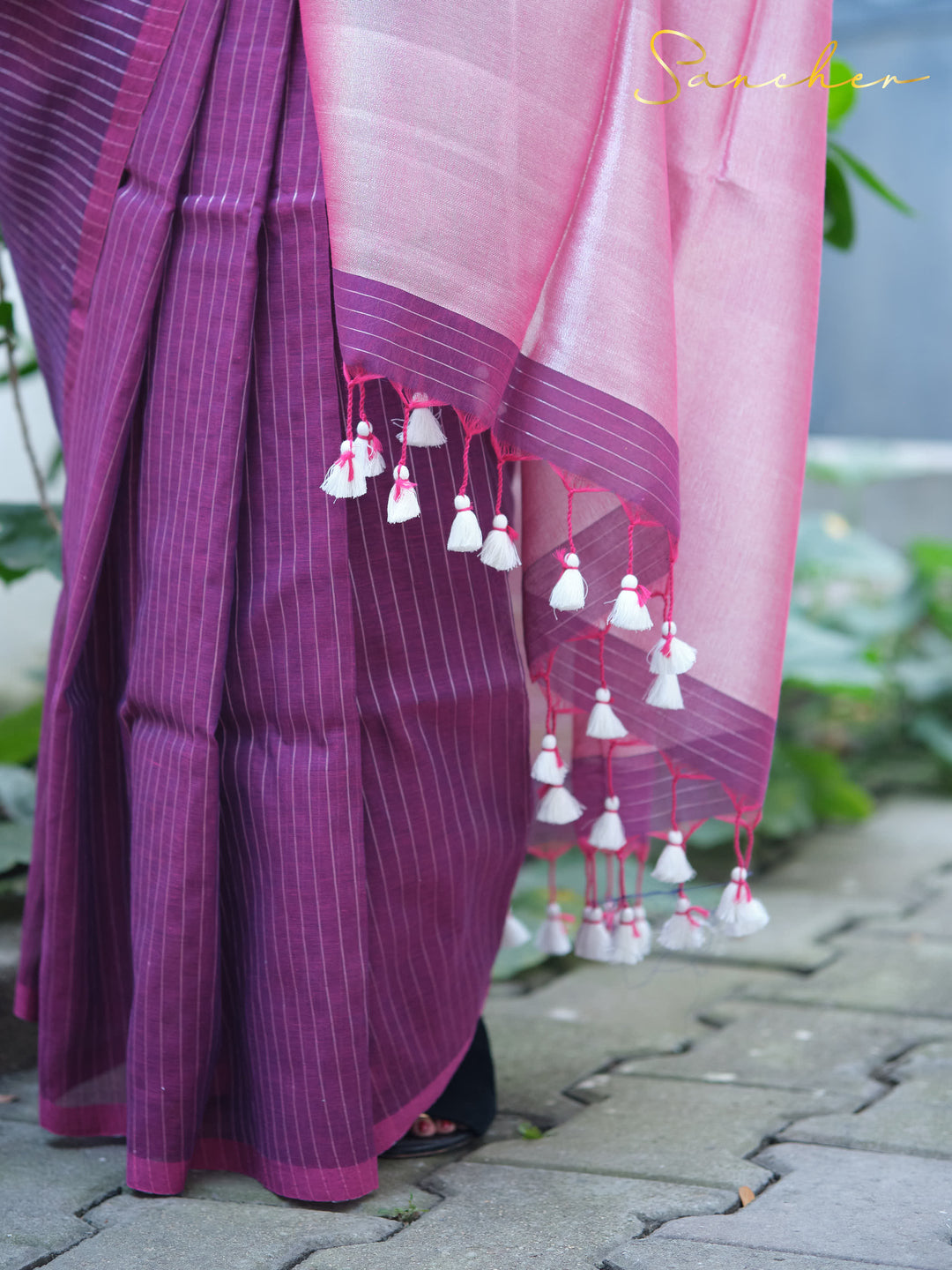 Close-up of purple striped mul cotton saree with pink border and white tassels, highlighting intricate details of casual sarees for office wear from Sancher boutique.