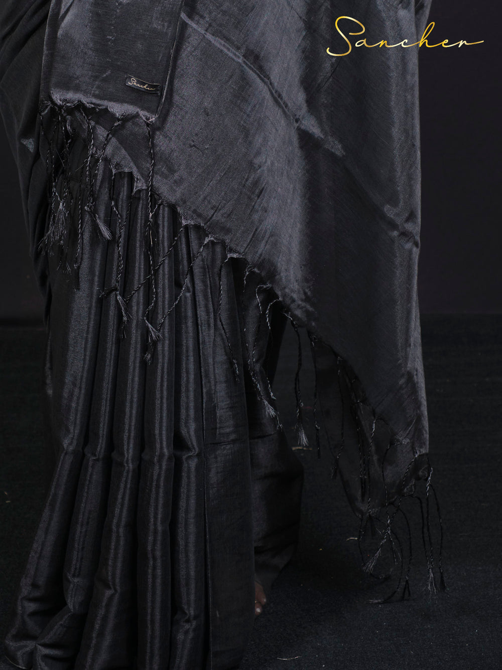Close-up detail of black mul zari saree fabric showing traditional weave and texture
