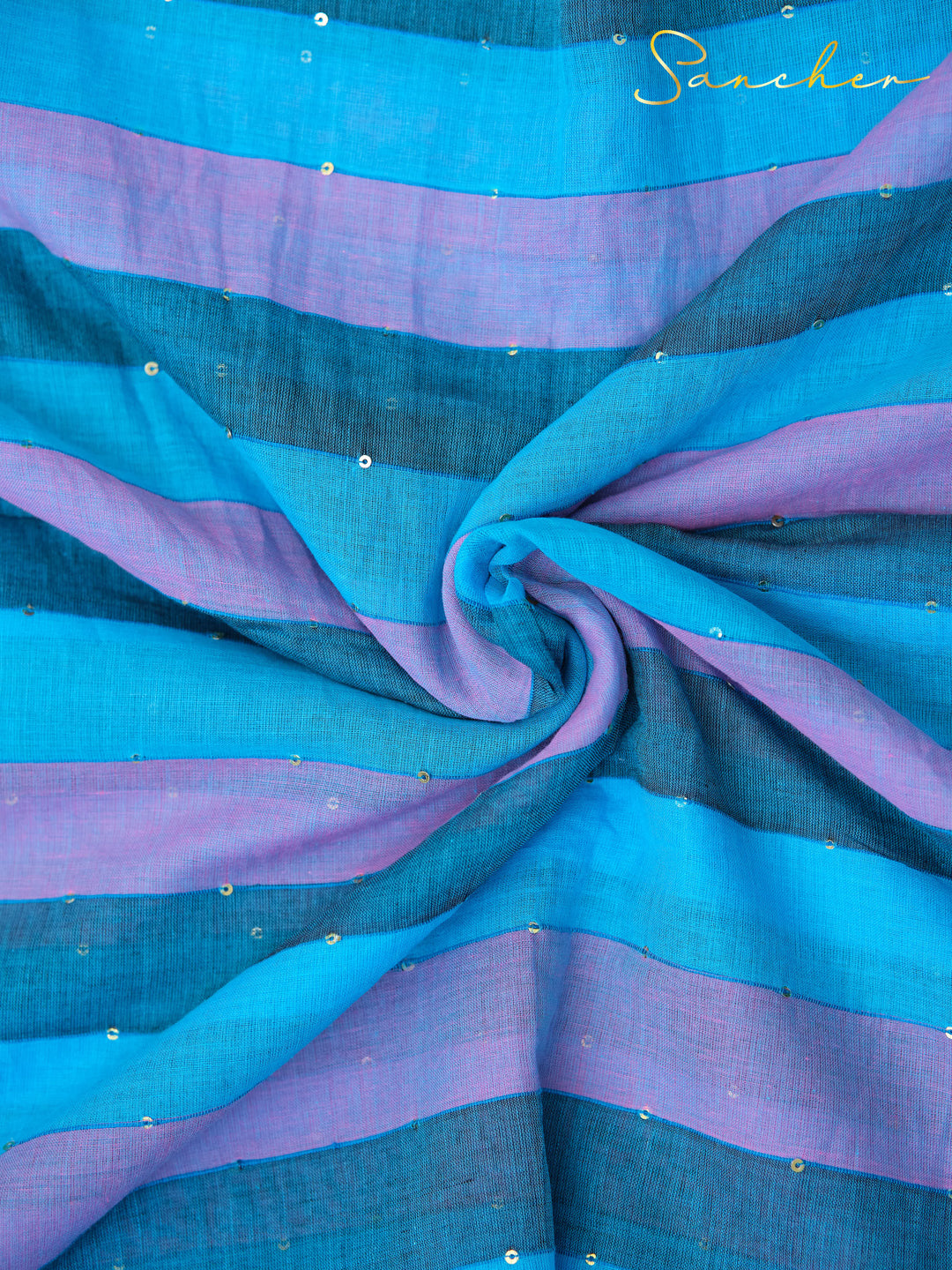 Draped blue and purple striped mulmul cotton saree fabric with sequin accents, showcasing the light, airy texture. Stylish professional office wear saree from Anna Nagar saree boutique.