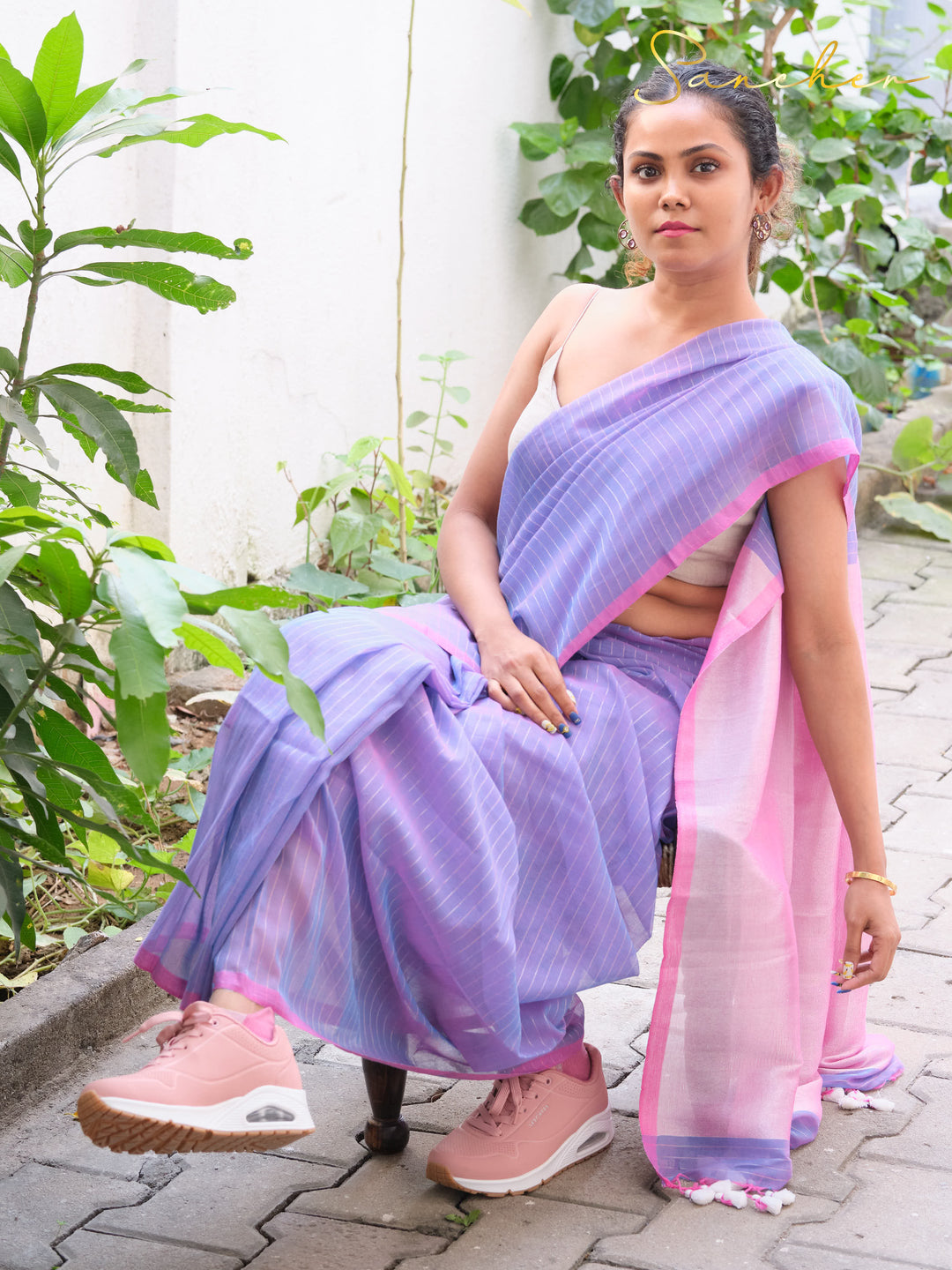 Woman in lavender and pink mul cotton saree from best saree shop in Anna Nagar, wearing pink sneakers for casual office wear, showcasing professional workwear sarees available at saree boutique in Anna Nagar and online.