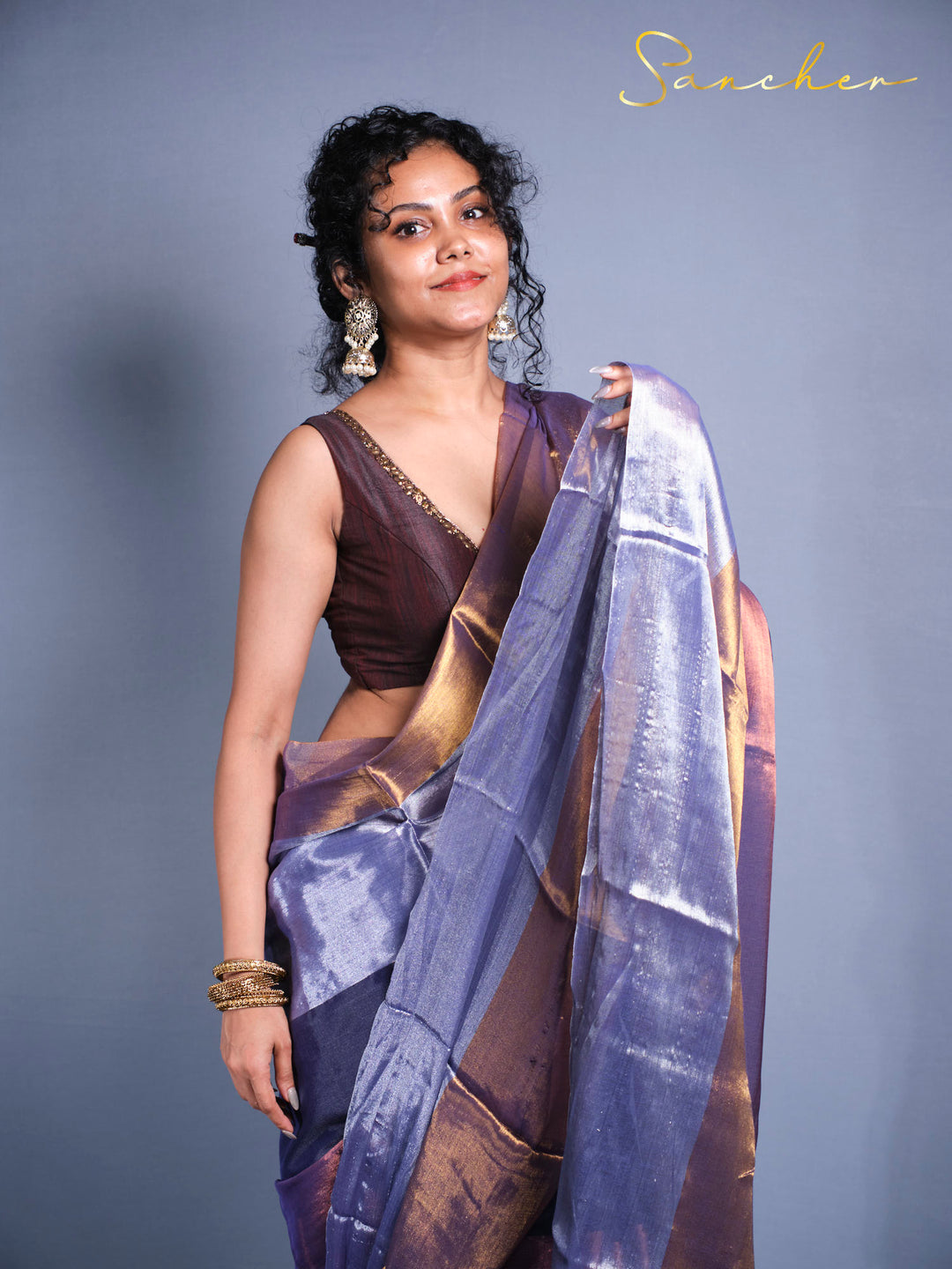  Woman wearing purple blue Mul Zari saree with golden shimmer front view